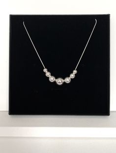 Fabulous substantial sterling silver floating ball necklace with a combination of a 14mm central ball, 2 x 12mm balls, 2 x 10mm balls and 2 x 8mm balls on a smooth sterling silver good quality snake chain. This is such a versatile necklace as you can change the look completely by removing balls, wear one ball to create a simple look or 3, 5 or all 7 in any combination to suit your mood or look. So many looks for the cost of one necklace. You have a choice of 2 chain lengths, 16 or 18 inches and your necklace will arrive in a gift box ready to give to that special person or as a treat to yourself. Silver Ball Necklace, Silver Chain Style, Ball Bracelet, Silver Snake Chain, Ball Necklace, Snake Chain, Chain Styles, Chain Lengths, Sterling Silber