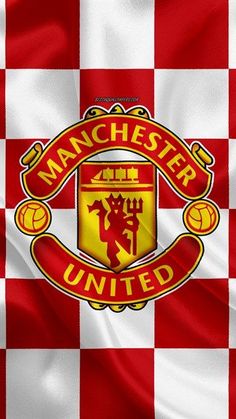 the manchester united logo on a red and white checkered background