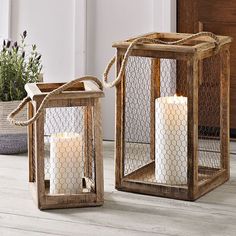 two wooden lanterns sitting on top of a white floor