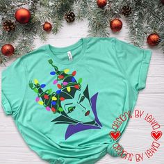 a t - shirt with an image of a woman's face and christmas lights on it