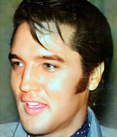 a close up of a person wearing a blue shirt and tie with his hair pulled back