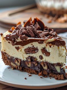 a piece of cheesecake with chocolate and nuts on top