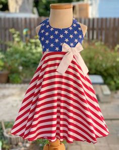 a red, white and blue dress on a mannequin with an american flag pattern