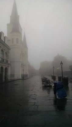 an image of a rainy street scene with umbrellas