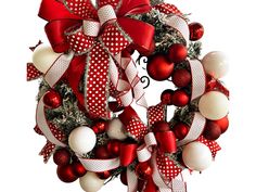 a red and white christmas wreath with ornaments