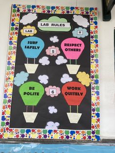 a bulletin board with hot air balloons on it and words that spell out the word lab rules