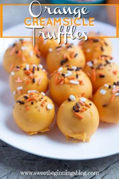 orange creamsicle truffles with sprinkles on a white plate