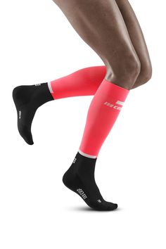 the legs and ankles of a person wearing red socks