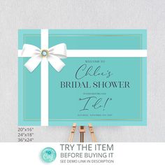 the bridal shower sign is shown with white ribbon and bow on it, next to ease