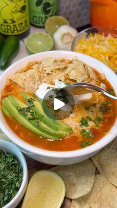 a bowl of soup with tortilla chips and salsa