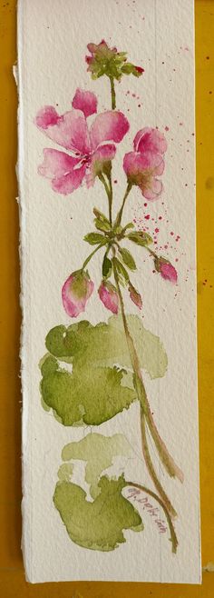 watercolor painting of pink flowers on white paper with green leaves and yellow wall in background