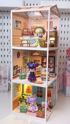 a doll house with furniture and accessories on display