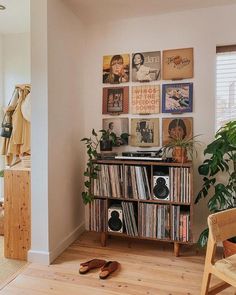 a living room filled with furniture and lots of pictures on the wall next to a window