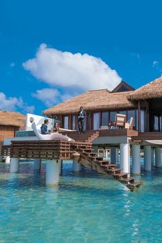 an over water villa with stairs leading to it