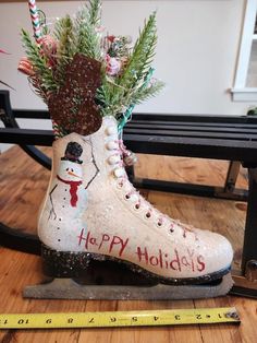 a pair of ice skates decorated with christmas decorations