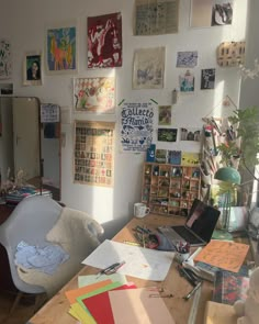 a room filled with lots of different types of art on the walls and desks