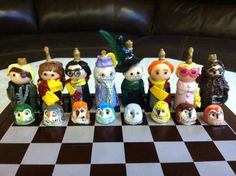 a group of figurines sitting on top of a checkered table