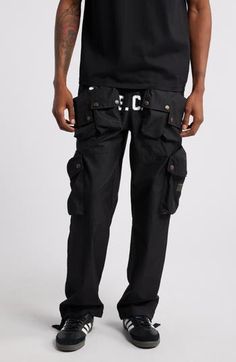 These cotton-blend cargo pants have an array of pockets and a slouchy silhouette for a streat-ready look. 30 1/2" inseam; 18" leg opening; 13" front rise; 16" back rise (size Medium) Elastic/drawstring waist Front snap-patch pockets; cargo snap-patch pockets; back decorative pocket flaps Lined 63% cotton, 37% nylon Hand wash, dry flat Imported Black Owned/Founded Techwear Cotton Cargo Pants With Flap Pockets, Combat Cotton Bottoms With Multiple Pockets, Cotton Combat Bottoms With Multiple Pockets, Urban Cargo Pants With Multiple Pockets, Urban Cargo Pants With Multiple Pockets For Streetwear, Straight Leg Parachute Pants With Cargo Pockets For Streetwear, Utility Parachute Pants With Multiple Pockets For Streetwear, Urban Cotton Parachute Pants With Flap Pockets, Cotton Parachute Pants With Flap Pockets For Streetwear