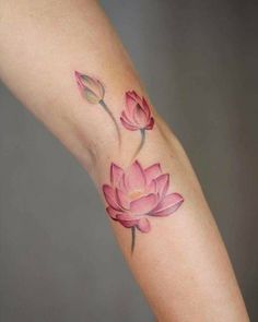 a woman's arm with a pink flower tattoo on the left side of her body