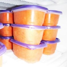 there are many plastic containers stacked on top of each other with purple lids and handles