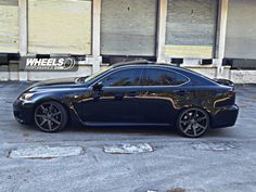 a black car parked in front of a building