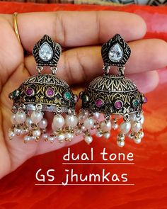 Oxidized German Silver - Dual Tone GS Jhumkas - Red/Green premium Quality and pushpin type closures.handcrafted with stones and pearls. Traditional Multicolor Dual-tone Earrings, Multicolor Dual-tone Earrings For Festivals, Festive Multicolor Dual-tone Earrings, Multicolor Dual-tone Earrings For Celebration, Multicolor Round Tilla Earrings, Handmade Multicolor Fusion Jhumkas, Multicolor Round Jhumkas As Gift, Multicolor Round Jhumkas For Gift, Handmade Multicolor Temple Jewelry Jhumkas