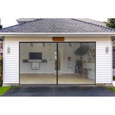 a garage with two bikes parked in front of it and a flat screen tv mounted on the wall