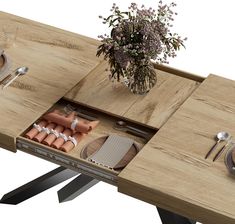 a wooden table with utensils, plates and silverware in an open drawer