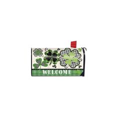 a green and white welcome sign with four leaf clovers