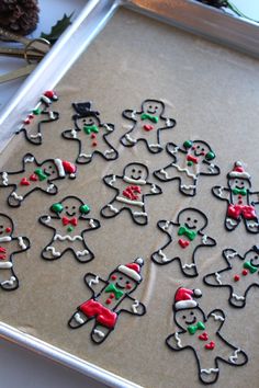 a cookie sheet decorated with christmas cookies and candy canes on a tray next to pine cones