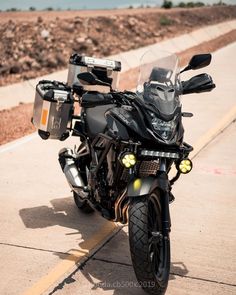 the motorcycle is parked on the side of the road