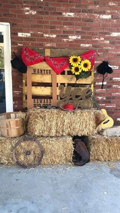 hay bales stacked on top of each other in front of a brick building