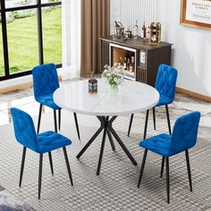 a white table with four blue chairs around it