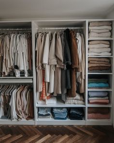 an organized closet with clothes and folded shirts