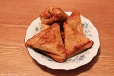 some fried food on a plate on a wooden table