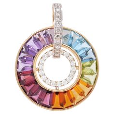 18 karat gold channel set rainbow multicolor gemstones diamond art deco circular pendant. A brilliant showcase of style awaits with our Rainbow Circle Diamond Pendant. This masterpiece is carefully crafted, featuring specially tapered baguette-cut diamonds set precisely, creating a stunning visual display. At its core, an inner circle adorned with radiant diamonds captivates with its mesmerizing shine. Surrounding this center, a mix of gemstones awaits, from calming blue topaz to vibrant citrine Multicolor Round Diamond Jewelry, Elegant Rainbow Diamond Jewelry, Rainbow Multi-stone Diamond Jewelry, Rainbow Diamond Jewelry With Multi-stone, Rainbow Round Diamond Jewelry, Rainbow Colored Round Diamond Jewelry, Modern Round Rainbow Jewelry, Modern Rainbow Round Jewelry, Elegant Round Rainbow Jewelry