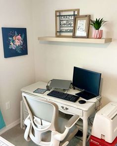 a desk with a computer and printer on it