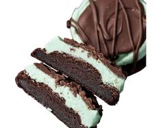 three pieces of chocolate cake with white and green frosting