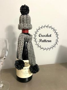 a bottle of wine with a knitted hat on top