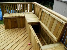 a wooden bench sitting on top of a wooden deck