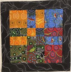 an art quilt with many different designs on it's sides, including birds and circles