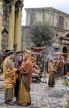 several people dressed in medieval clothing standing outside