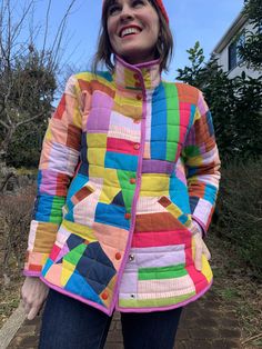 a woman wearing a colorful jacket and hat