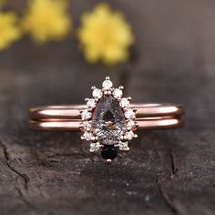 a close up of a diamond ring on a wooden surface