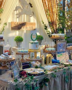 a table topped with lots of cakes and desserts