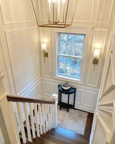 an overhead view of a staircase leading up to a window in a white painted house