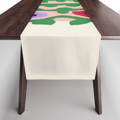 the table is covered with an artisticly designed cloth on it's long legs