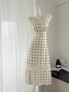 Bare the essence of sophistication with this stunning polka dot dress, meticulously crafted to enhance your natural beauty. The intricate lace trim adds a touch of femininity, elevating the classic polka dot pattern to new heights. The dress features a structured bodice that provides support and shape, complemented by a flowing skirt that moves gracefully with you. Made from premium quality fabric, this dress ensures breathability and comfort, making it perfect for any season. The adjustable spa Summer Lace Polka Dot Dress, Fitted Lace Dress With Swiss Dot Details, Chic Lace Polka Dot Dress, Chic Lace Dress In Polka Dot, Chic Polka Dot Dresses With Lace Trim, Chic Polka Dot Lace Dress, Polka Dot Swiss Dot Midi Dress, Fitted Polka Dot Midi Dress With Swiss Dot Details, Elegant Polka Dot Dress With Square Neck