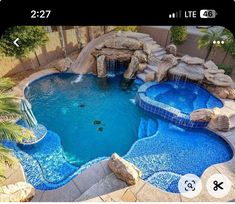 a pool with a waterfall in the middle and some rocks on the sides, next to a rock slide