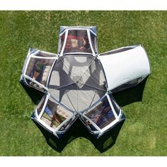 an overhead view of a tent with people in it sitting on the grass and looking down